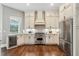 Gourmet kitchen with granite countertops, stainless steel appliances, and a built-in wine cooler at 8214 Lake Serene Dr, Orlando, FL 32836