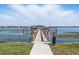 Scenic view of a wooden pier extending into a tranquil lake, perfect for leisurely strolls and water activities at 8214 Lake Serene Dr, Orlando, FL 32836