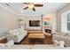 Cozy living room features a fireplace, hardwood floors, and an abundance of natural light at 8214 Lake Serene Dr, Orlando, FL 32836