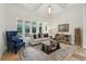 Bright living room with neutral-colored furniture, a patterned rug, and views of the backyard pool at 8214 Lake Serene Dr, Orlando, FL 32836