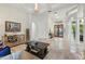 A well-lit living room showcasing tiled floors, an elegant chandelier and arched doorways leading to other rooms at 8214 Lake Serene Dr, Orlando, FL 32836