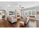 Comfortable living room with a fireplace, hardwood floors, and large windows overlooking the backyard at 8214 Lake Serene Dr, Orlando, FL 32836