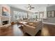 Open-concept living room with fireplace, hardwood floors, and views into the kitchen at 8214 Lake Serene Dr, Orlando, FL 32836