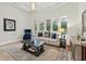 Bright living room with neutral-colored furniture, a patterned rug, and views of the backyard pool at 8214 Lake Serene Dr, Orlando, FL 32836