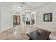 Well-lit living room featuring tiled floors, arched doorways, and a beautiful chandelier overlooking the dining area at 8214 Lake Serene Dr, Orlando, FL 32836