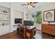 Comfortable office space with beautiful hardwood floors, built-in shelving, and a large window overlooking the property at 8214 Lake Serene Dr, Orlando, FL 32836