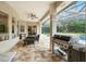 Covered patio with a ceiling fan, dining area, and a built-in grill, perfect for outdoor entertaining at 8214 Lake Serene Dr, Orlando, FL 32836