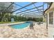Large screened-in pool with a hot tub, basketball hoop, and outdoor seating, perfect for Gathering fun and relaxation at 8214 Lake Serene Dr, Orlando, FL 32836