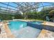Beautiful screened-in pool and spa with a tiled hot tub and an in-ground pool, surrounded by landscaped pavers at 8214 Lake Serene Dr, Orlando, FL 32836