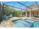 Inviting pool with a connected jacuzzi, outdoor seating, and a screened-in enclosure, ideal for relaxation and enjoyment at 8214 Lake Serene Dr, Orlando, FL 32836