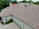 Overhead view of a house roof with a two-car garage and brick driveway at 8214 Lake Serene Dr, Orlando, FL 32836