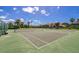 Community tennis courts surrounded by green trees and blue sky at 8214 Lake Serene Dr, Orlando, FL 32836