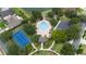 Aerial view of the community highlighting the pool, tennis courts, lush landscaping, and surrounding neighborhood, showcases the amenities at 832 Seneca Trl, St Cloud, FL 34772