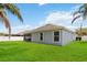 Spacious backyard featuring green grass, a white fence, and tall palm trees at 832 Seneca Trl, St Cloud, FL 34772