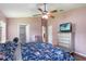 Comfortable bedroom featuring ceiling fan, and three access doors at 832 Seneca Trl, St Cloud, FL 34772
