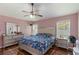 Comfortable bedroom with warm paint, ceiling fan, and plenty of space at 832 Seneca Trl, St Cloud, FL 34772