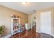 Bedroom with hardwood floors and a white bookshelf with a doorway leading to the hallway at 832 Seneca Trl, St Cloud, FL 34772