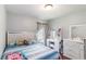 Bright bedroom with a vanity, modern furniture, and lots of natural light at 832 Seneca Trl, St Cloud, FL 34772
