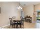 Cozy dining area featuring a marble-top table and chairs with a bar and sliding doors at 832 Seneca Trl, St Cloud, FL 34772