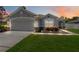 Charming single Gathering home with a well-manicured lawn and beautiful landscaping at dusk at 832 Seneca Trl, St Cloud, FL 34772