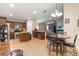 Open-concept kitchen featuring dark wood cabinets, stainless steel appliances, and a breakfast nook at 832 Seneca Trl, St Cloud, FL 34772