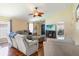 Cozy living room with ceiling fan, hardwood floors and open layout to door and office at 832 Seneca Trl, St Cloud, FL 34772