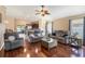 Comfortable living room with ceiling fan, wood floors and open layout to dining and kitchen at 832 Seneca Trl, St Cloud, FL 34772