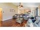 Comfortable living room with ceiling fan, wood floors and open layout to dining and kitchen at 832 Seneca Trl, St Cloud, FL 34772
