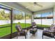 Screened porch featuring comfortable seating and view to backyard at 832 Seneca Trl, St Cloud, FL 34772