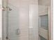 Modern bathroom featuring a glass-enclosed shower with stylish tile work and a built-in shower niche at 8359 Lookout Pointe Dr, Windermere, FL 34786