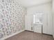 Bright bedroom with floral wallpaper, neutral-toned flooring, and built in shelving units at 8359 Lookout Pointe Dr, Windermere, FL 34786
