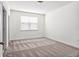 Neutral bedroom with new carpet, a large window, and plenty of natural light at 8359 Lookout Pointe Dr, Windermere, FL 34786