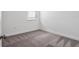 This empty bedroom offers neutral carpet flooring, trim and natural light at 8359 Lookout Pointe Dr, Windermere, FL 34786