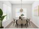 Bright dining room featuring neutral decor, a modern chandelier, and large windows with great natural lighting at 8359 Lookout Pointe Dr, Windermere, FL 34786