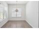 Bright dining room with large windows, neutral walls, and a decorative chandelier, creating an inviting atmosphere at 8359 Lookout Pointe Dr, Windermere, FL 34786