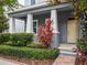 Charming front porch featuring elegant columns, manicured landscaping, and a welcoming entrance at 8359 Lookout Pointe Dr, Windermere, FL 34786