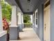Spacious front porch with elegant columns, offering a welcoming and shaded entrance to the home at 8359 Lookout Pointe Dr, Windermere, FL 34786
