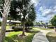 Community gazebo with tables and seating, surrounded by lush landscaping and palm trees near the pool area at 8359 Lookout Pointe Dr, Windermere, FL 34786
