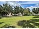 Lush green space with manicured lawn, mature trees, and black metal fencing in a well-maintained community at 8359 Lookout Pointe Dr, Windermere, FL 34786