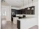 Updated kitchen has dark wood cabinets, a breakfast bar and white shiplap accents at 8359 Lookout Pointe Dr, Windermere, FL 34786