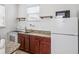 Efficient kitchen with granite countertops, wood cabinets, and a Hotpoint refrigerator at 8359 Lookout Pointe Dr, Windermere, FL 34786