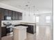 Open-concept kitchen with an island and a view to the dining and living spaces at 8359 Lookout Pointe Dr, Windermere, FL 34786