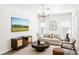 Stylish living room featuring contemporary decor, a modern light fixture, and ample natural light at 8359 Lookout Pointe Dr, Windermere, FL 34786