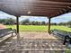Park view from under a wooden pergola featuring two benches at 8359 Lookout Pointe Dr, Windermere, FL 34786