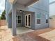 Cozy covered patio with ceiling fan, brick detail, and access to backyard at 8359 Lookout Pointe Dr, Windermere, FL 34786