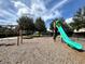 Community playground features swings and a slide, all within a safe, fenced area at 8359 Lookout Pointe Dr, Windermere, FL 34786