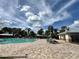 Community pool area featuring lounge chairs and a bath house for residents' enjoyment at 8359 Lookout Pointe Dr, Windermere, FL 34786