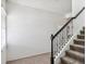 Carpeted staircase with wrought iron railings and white shiplap accents at 8359 Lookout Pointe Dr, Windermere, FL 34786
