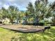 Blue swings on a wood-chip playground, with mature trees and green spaces visible in a Gathering-friendly community at 8359 Lookout Pointe Dr, Windermere, FL 34786