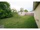 The backyard features a storage shed, lush greenery, and a well-maintained lawn at 956 Florida Pkwy, Kissimmee, FL 34743